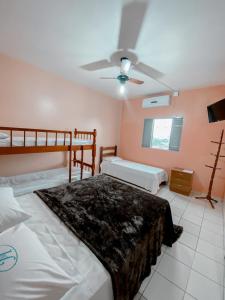 a bedroom with two beds and a ceiling fan at Manhattan Hotel in Caldas Novas +21 photos