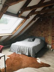 a attic room with a bed in a brick wall at Martins Guesthouse Zimmer in Hannover