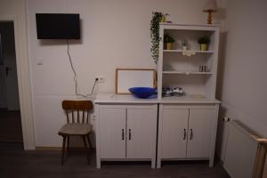 a white desk with a mirror and a chair at Gasthof Bittner in Meinerzhagen