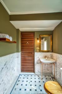 a bathroom with a sink and a mirror at Clarks Exotica Island House, Portblair in Port Blair