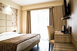 Postel nebo postele na pokoji v ubytování Hotel Pineta Palace