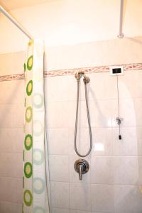 a shower in a bathroom with a shower curtain at Hotel I 4 Assi in Viareggio