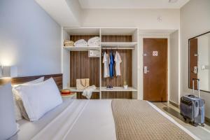 Postel nebo postele na pokoji v ubytování Tambaqui Praia Hotel
