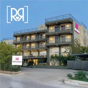 a tall building with a sign in front of it at Ruby Rooms Kifisia in Athens