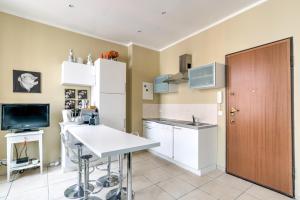 a kitchen with white cabinets and a sink at IMMOGROOM - Historic Area Le Suquet - 6min from the beaches in Cannes