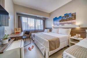 Postel nebo postele na pokoji v ubytování Tambaqui Praia Hotel