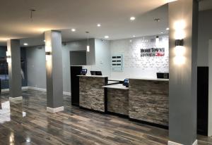 a lobby with a reception desk in a building at HomeTowne Studios by Red Roof San Antonio E - Frost Bank Center in San Antonio