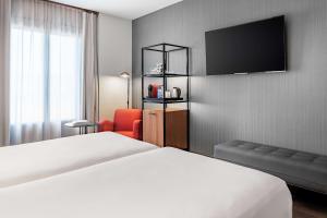 a hotel room with a bed and a television at NH Collection León Plaza Mayor in León