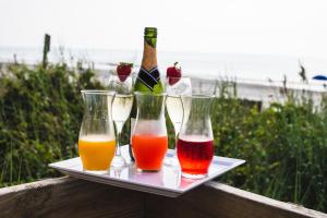 a tray with four wine glasses and bottles on it at Holiday Inn Resort Oceanfront at Surfside Beach, an IHG Hotel in Myrtle Beach