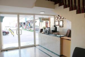 a restaurant with a counter and a view of a street at Al Nile Hotel in Salalah