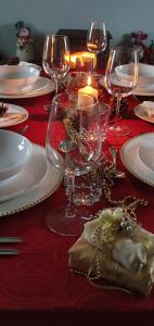 a red table with plates and glasses and a candle at Bay View House in Liscannor +37 photos