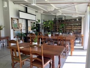 a restaurant with wooden tables and chairs and books at Cranberry Cottage in Ladybrand