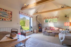 a living room with a couch and a table at Romantic cottage in pretty village with great pubs - Stoke Cartlodge in Colchester