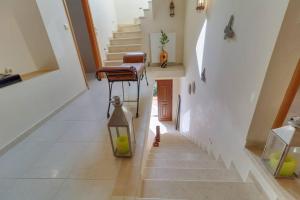 a staircase with a chair and a lantern in a house at Eagle Nest Villa in Antikyra