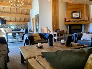 a living room with couches and a table with candles at Chalet Victoria in Sainte-Foy-Tarentaise