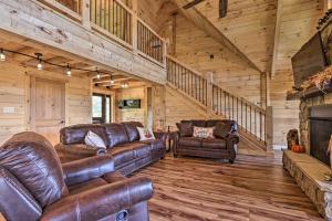 
a living room filled with furniture and a fire place at Spacious Mountain Retreat with Hot Tub and Views! in Gatlinburg
