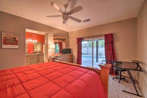 a bedroom with a red bed and a desk and a window at Gateway Grand Oasis Private Palm Springs Escape! in Palm Springs