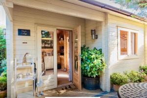 a door to a house with a potted plant at Duck Lodge B&B with Hot Tub in Pyecombe