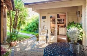 a patio with a table in front of a house at Duck Lodge B&B in Pyecombe +11 photos