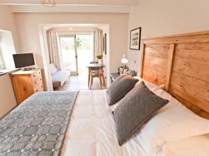 a bedroom with a large bed with a wooden headboard at Grove Park in Newport Pembrokeshire
