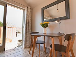 a dining room with a table and chairs and a window at Grove Park in Newport