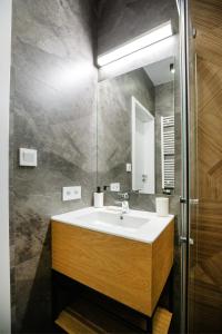 a bathroom with a sink and a mirror at iroom in Lublin