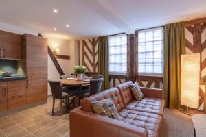 a living room with a couch and a table at La Venelle Saint Jean in Honfleur