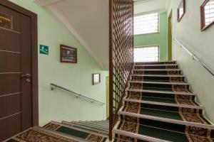 a staircase in a room with green walls at Pansionat Iskra in Pyatigorsk