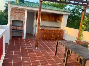 une terrasse avec une table et une cuisine dans une maison dans l'établissement Casa El Mangle, à Carthagène des Indes