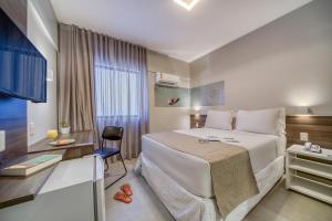 Postel nebo postele na pokoji v ubytování Tambaqui Praia Hotel