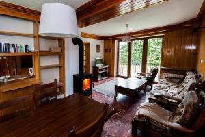 a living room with a table and a fireplace at Krynica Zamkowa 48 in Krynica Zdrój