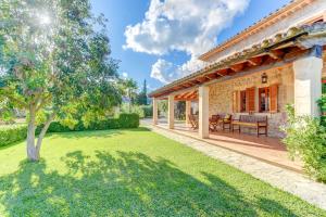 a home with a patio and grass yard at Finca Malena in Caimari