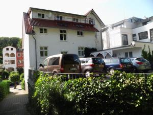 un grupo de coches estacionados frente a un edificio en Apartments Haus Eintracht Sellin, en Ostseebad Sellin