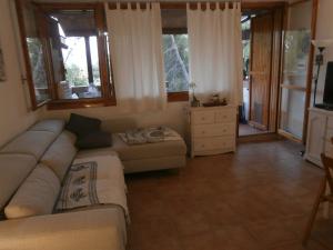 a living room with a couch and a table at Casa Luciana in Cugnana Verde