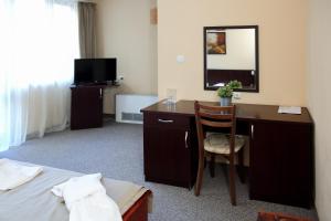 a hotel room with a desk and a bed at Hotel Complex Chayka in Vratsa