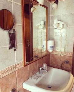 a bathroom with a sink and a mirror at Aparthotel Es de Don Joan in Unha