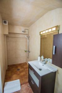 a bathroom with a sink and a shower at La Finca Blanca in Alora
