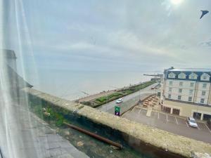 a view from a window of a street and the ocean at Oceana Holiday Apartments in Bridlington