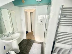 a bathroom with a sink and a shower at Oceana Holiday Apartments in Bridlington