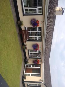an aerial view of a building with flowers on the windows at Atlantic House in Lisdoonvarna