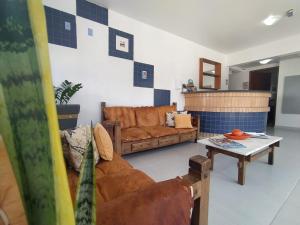 a living room with a couch and a table at Coliseu Palace Residence in Florianópolis +87 photos