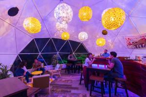 a group of people sitting in a tent with a pool table at Chira Glamping Resort Monteverde in Monteverde Costa Rica