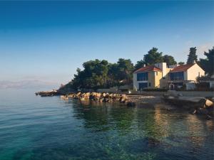 a house on the shore of a body of water at Villas Violet & Rosemary in Supetar