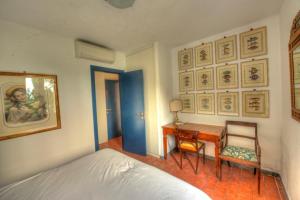 a bedroom with a bed and a desk and a table at La Casa Del Pescatore B&B in Portovenere