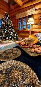 a table with plates of food and a christmas tree at Sunset House in Ulmale