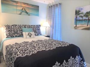 una camera con un letto bianco e nero e una finestra di Dockside Daze! a Galveston