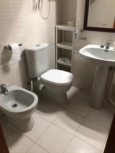 a bathroom with a toilet and a sink at Miraplaya in Benicàssim
