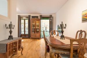 a dining room with a wooden table and chairs at Art Nouveau Apartment in Barcelona