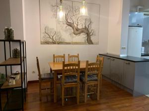 a kitchen with a table and chairs in a room at Atico Jaca Centro in Jaca +10 photos