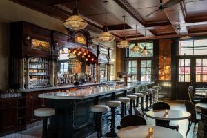 a bar with tables and chairs in a restaurant at The Holbrooke Hotel in Grass Valley